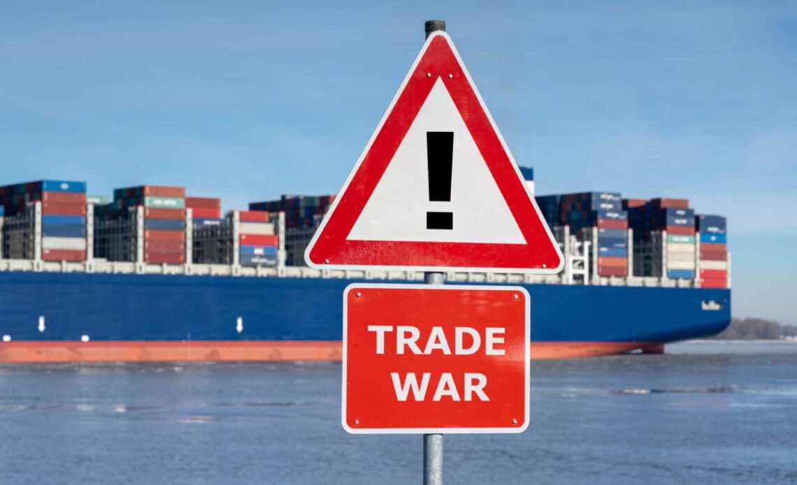 Warning sign with the text "Trade war" in front of container ship